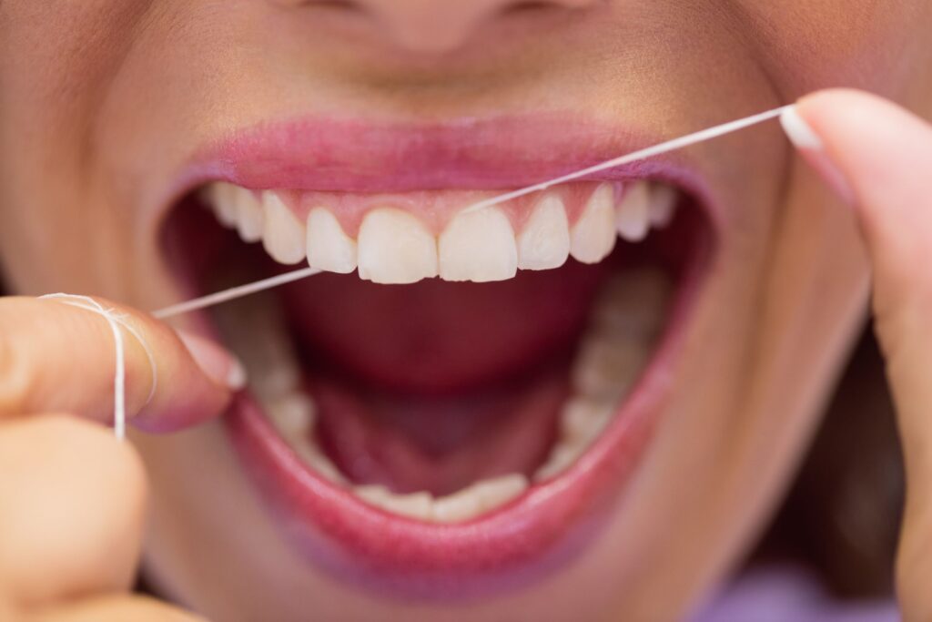 Proper dental flossing technique demonstration at Mary St Dental Gympie for optimal oral hygiene and preventive care