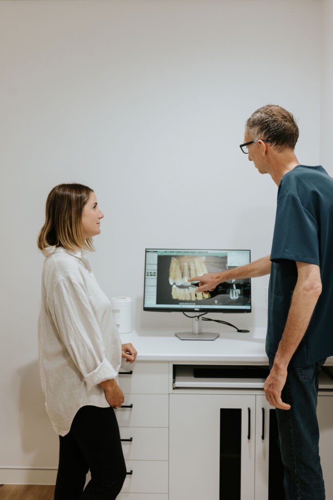 Dentist explaining dental scan results to a patient at Mary Street Dental in Gympie