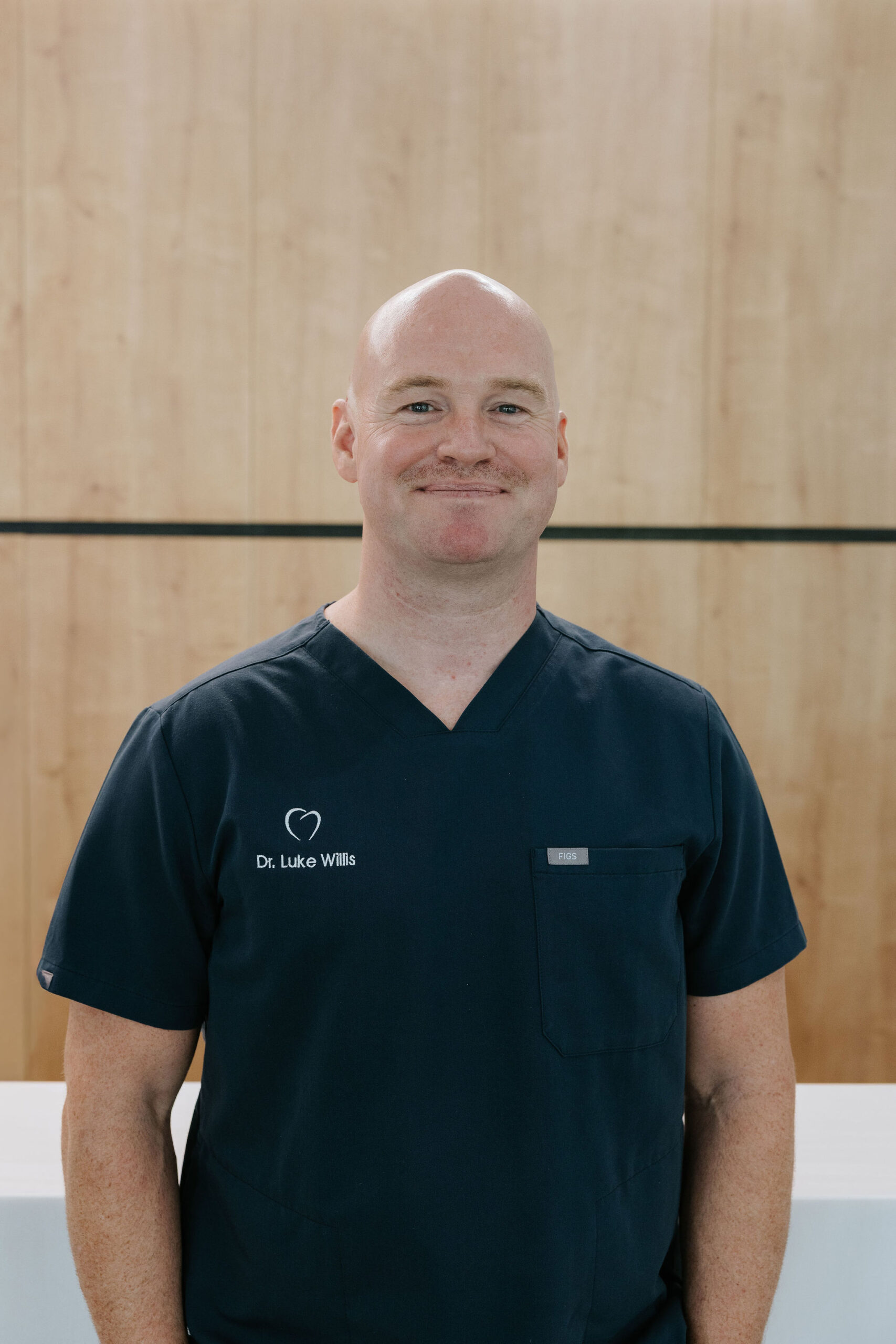 Professional headshot of Dr. Luke Willis, dentist at Mary St Dental Gympie, wearing professional medical attire and smiling.