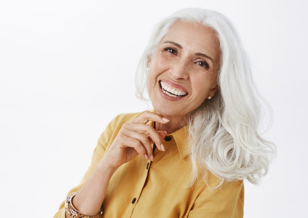 A smiling woman showing healthy white teeth after cosmetic dentistry treatment. Cosmetic dentistry services near Curra include teeth whitening, veneers and smile enhancements designed to improve the appearance of your smile.