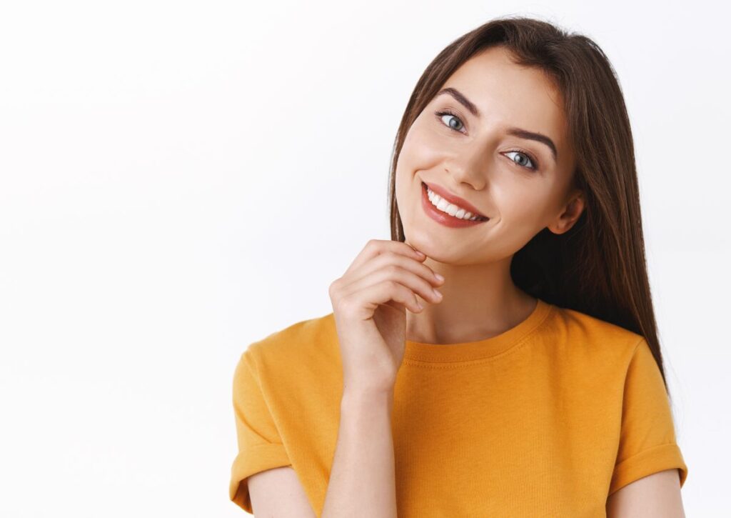 Smiling patient showing healthy teeth after regular dental checkups
