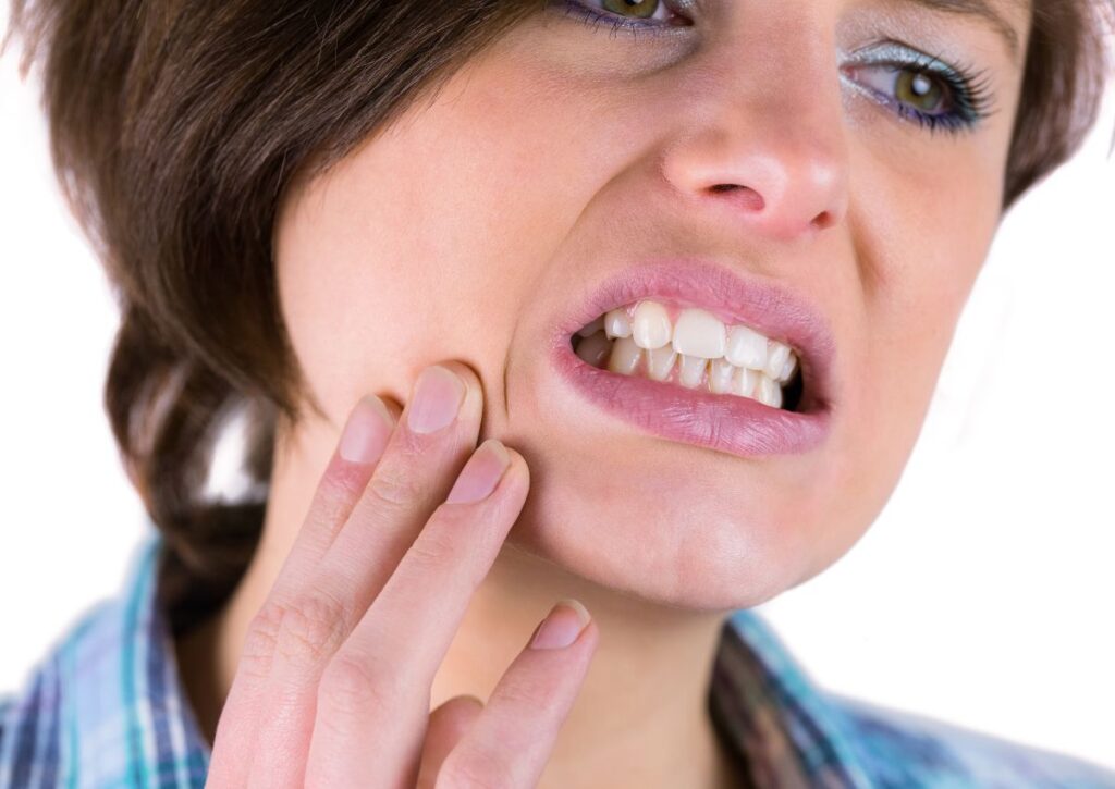 Person clenching teeth from bruxism needing teeth grinding treatment in Gympie